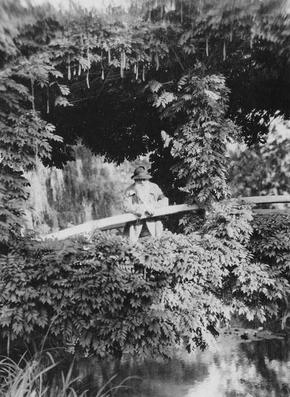 Claude Monet (1841-1926) on the Japanese Bridge in his garden at Giverny, c.1920 (b/w photo)  a French Photographer