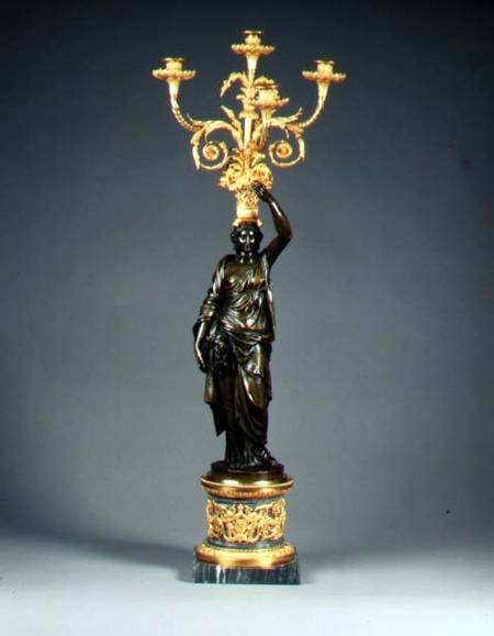 Louis XVI four-light candelabraormolu branches rising from a basket balanced on the head of a patina a Anonimo