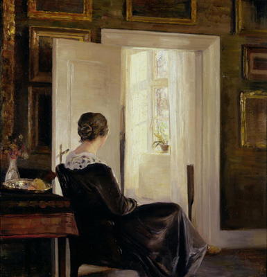 A woman seated near a door a Carl Holsoe