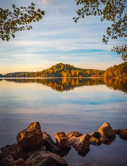 Autumn lake with a small mountain in the background