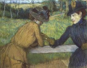 Two women leaning on a gate