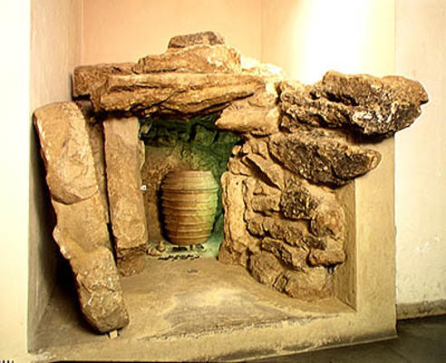 Reconstruction of an Etruscan tomb with an urn (stone) a Etruscan