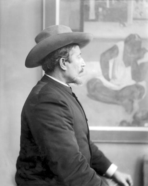 Paul Gauguin (1848-1903) in front of his canvases (b/w photo)  a Scuola Francese