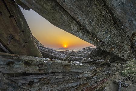 sunrise among ruins of ship