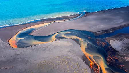 Aerial Serenade of Colorful Creeks Meeting the Sea