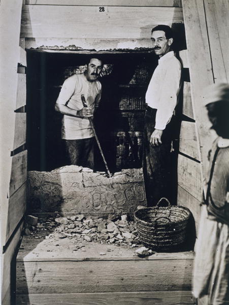 Howard Carter (1873-1939) and a colleague standing beside a partially demolished wall to one of the  a Harry Burton