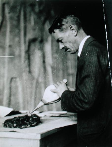 Mr Mace, Associate Curator of the Metropolitan Museum of Art, New York, treating one of the objects  a Harry Burton