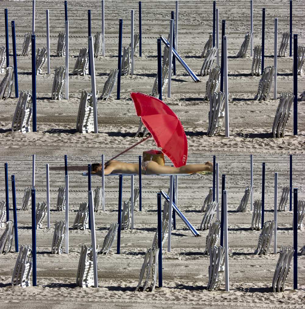 Composition of poles and chairs with red umbrella a Jois Domont