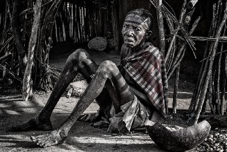 Elderly woman at the entrance of her home in a Laarim tribe village.