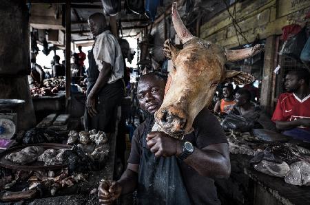 A butcher with a cows head - Ghana