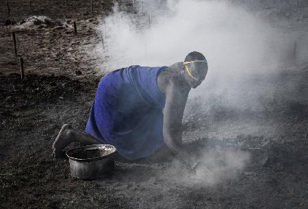 Mundari woman collecting dung - South Sudan