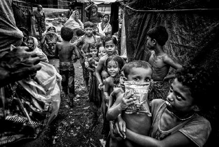 Rohingya refugee children queuing to receive some snacks - Bangladesh