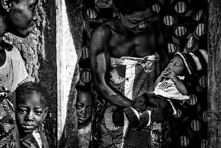 Proudly showing her newborn child - Benin