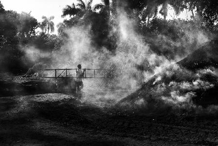 A charcoal worker with a ladder