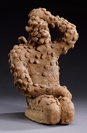 A Djenne Terracotta Kneeling Male Figure, 14th Century a 