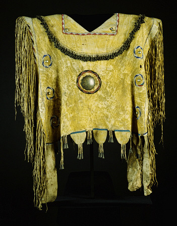 An Apache Beaded And Fringed Buckskin Poncho, Painted With Yelloe Ochre And Decorated With Tin Cones a 