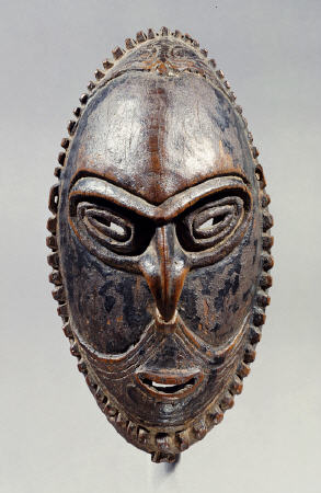 A New Guinea Mask Of Oval Form With Pierced Eyes, Mouth And Septum a 