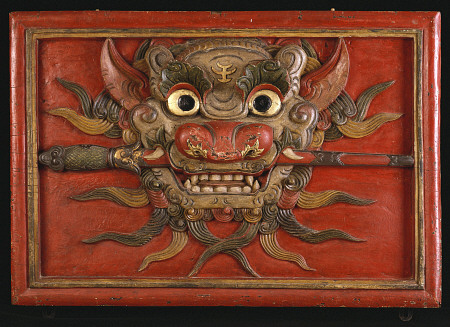 A Tibetan Polychrome Wooden Panel Carved In High Relief With A Kala Mask, 19th Century a 