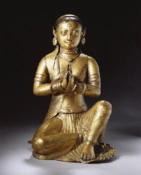 A Nepalese Embossed Gilt-Copper Figure Of A Worshipping Queen, Early 18th Century