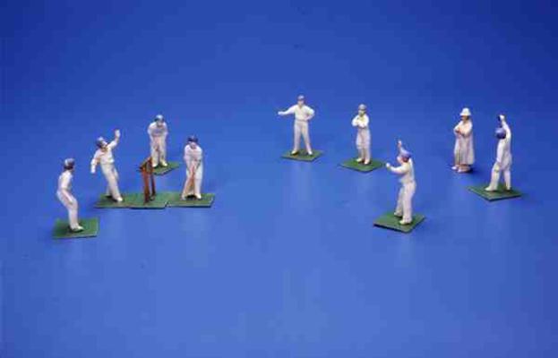 Eleven German bisque figures of cricketers and an umpire (painted lead) a 