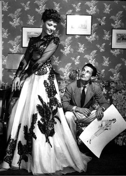 fashion designer Oleg Cassini showing his drawings to Gene Tierney to show her the clothes for film  a 