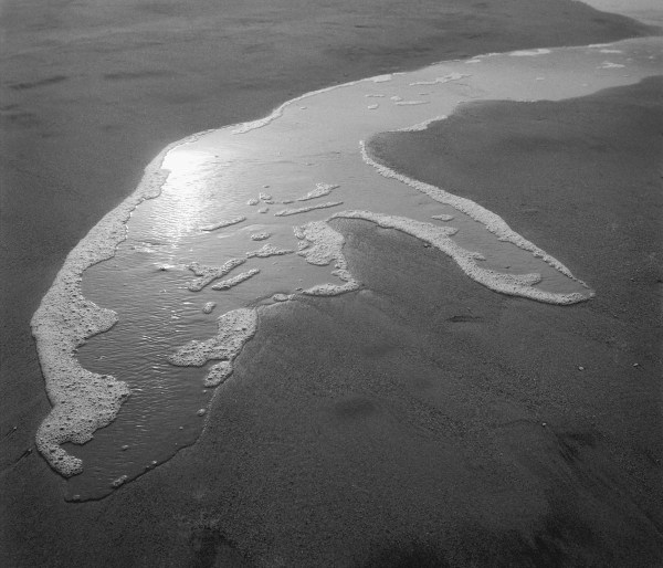 Foam water on sand, Porbandar (b/w photo)  a 