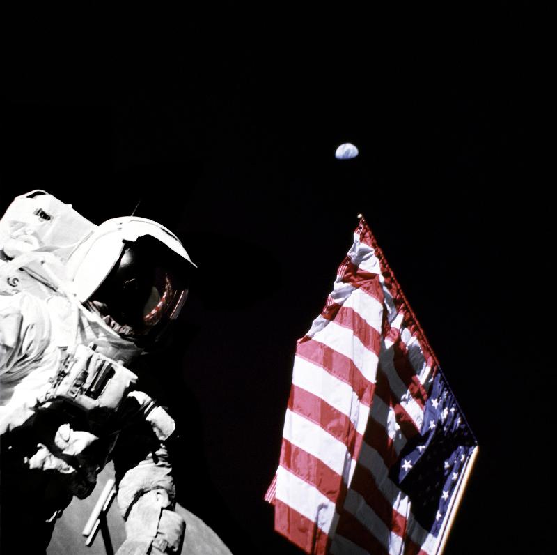 Geologist-Astronaut Harrison Schmitt, Apollo 17 Lunar Module pilot, is photographed next to the Amer a 