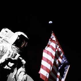 Geologist-Astronaut Harrison Schmitt, Apollo 17 Lunar Module pilot, is photographed next to the Amer