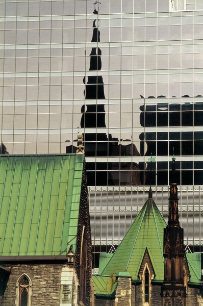 Green roofs and church reflected in glass panels (photo)  a 