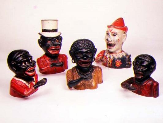 Group of Mechanical cast iron money banks. Left to right: Jolly Nigger with Butterfly Tie, Jolly Nig a 