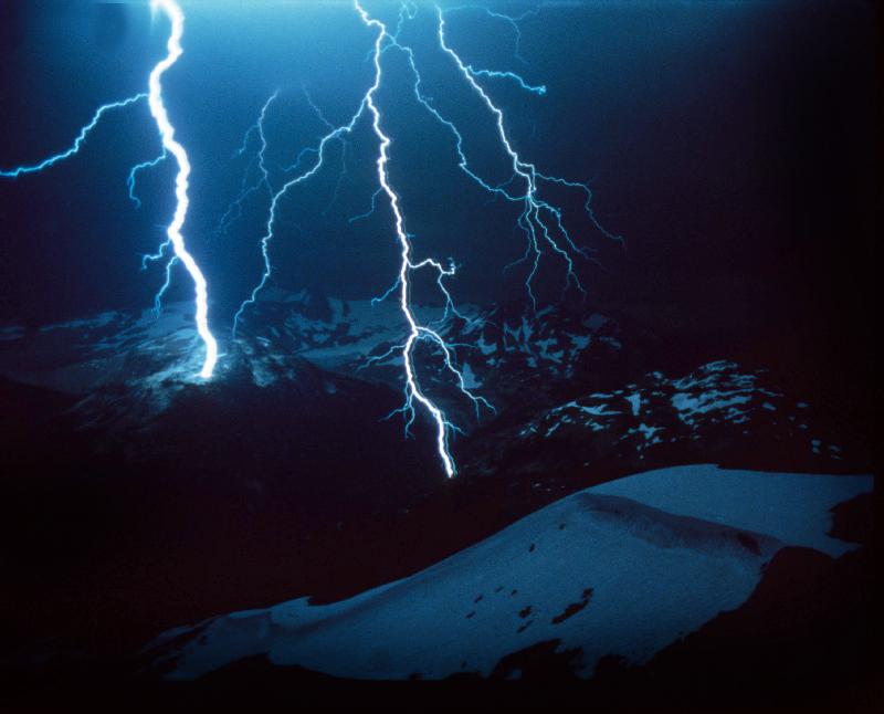 Lightning during a storm over snowy mountains a 