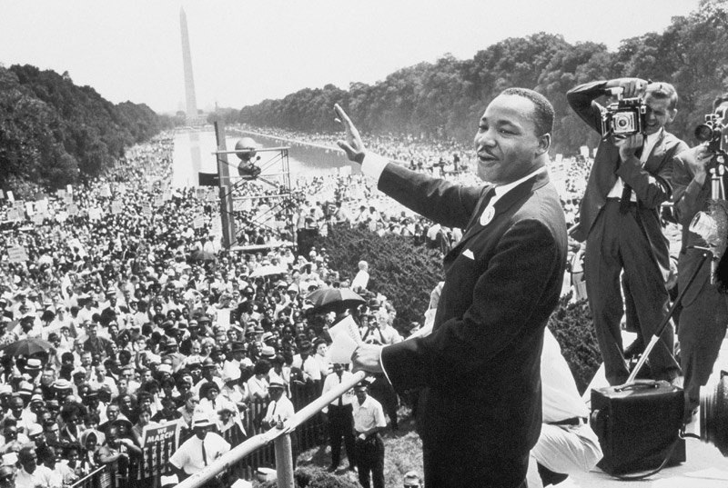 Martin Luther King American priest activist for Civil Right Movement of black Americans saluting the a 