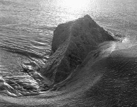Rock in sea water (b/w photo) 