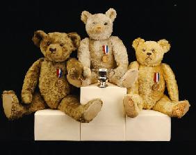 Three Farnell Teddy Bears On A Medal Winners Plinth