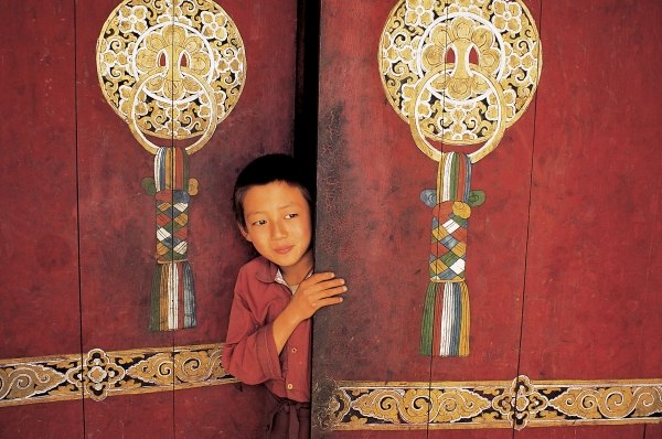 Young initiate outside main door of Pemyangtse monastery (photo)  a 