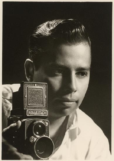 Orlando Suero portrait with Rolleiflex camera, c