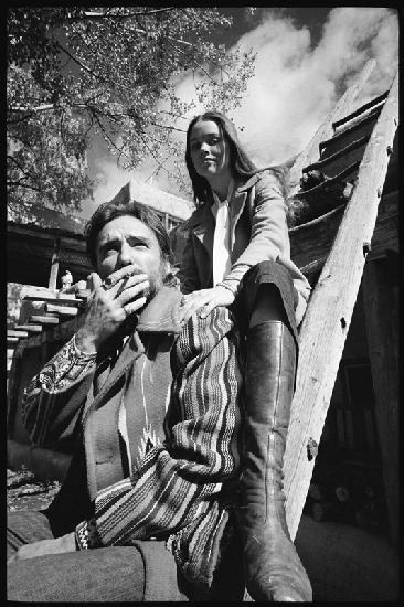 Dennis Hopper and wife Michelle Phillips on a ladder in New Mexico