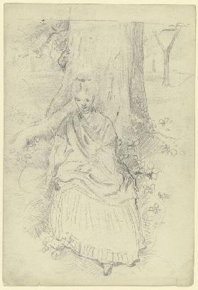Luise Scholderer, an einem Baumstamm sitzend