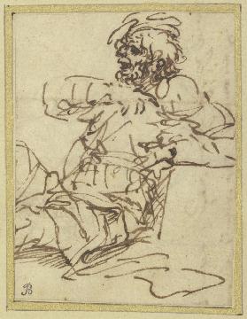 A man seated against a block on the right