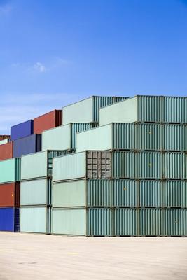 shipping containers against blue sky a Sascha Burkard