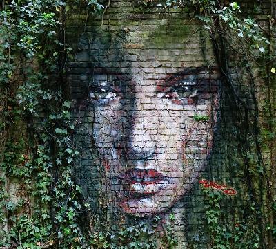 A fairy is looking through the ivy branches