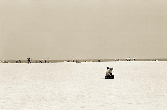 Man sitting on a beach playing his horn, 2004 (b/w photo)  a Stephen  Spiller