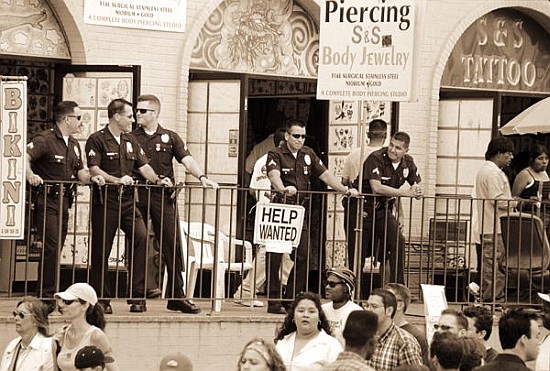 Police gathered behind a ''Help Wanted'' sign, 2004 (b/w photo)  a Stephen  Spiller