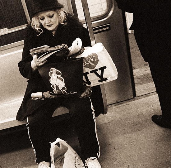 Woman reading on a subway with a Marilyn Monroe purse and an ''I Love New York'' bag, 2004 (b/w phot a Stephen  Spiller