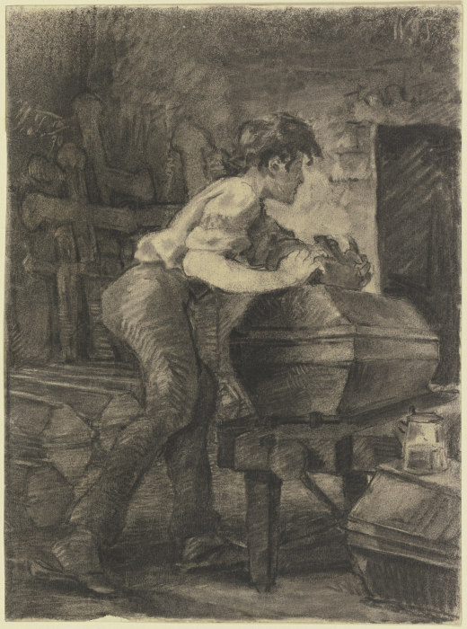 Ein junger Schreiner hobelt in der Werkstatt an einem Sarg a Wilhelm Trübner