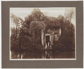 Young men in antique costume in front of a ruin in Sicily